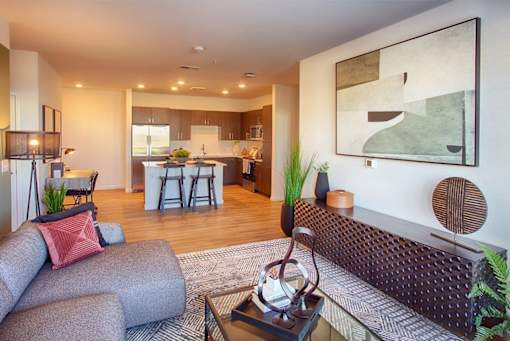 A modern living room with a grey couch and a coffee table.