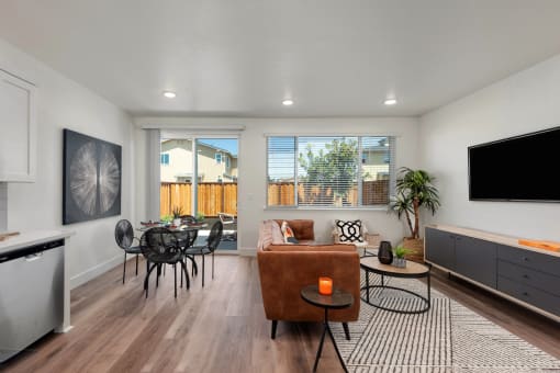 a living room with a couch and a table and a television