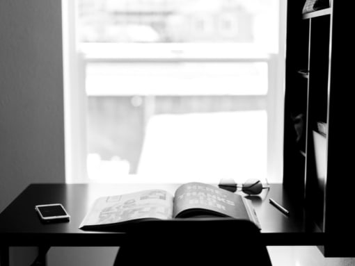 a book sitting on top of a desk next to a window