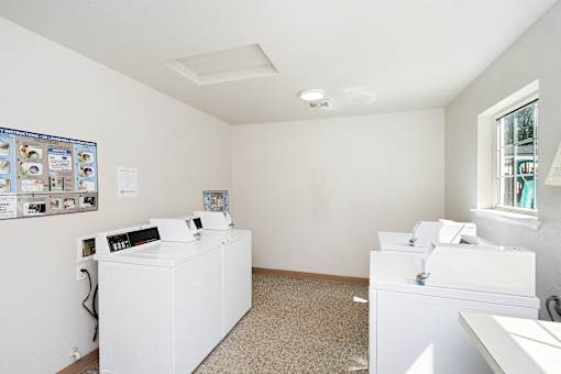 A bathroom with a white sink and toiletries.