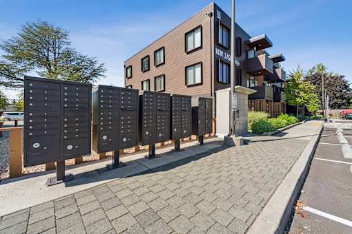 A modern building with a row of mailboxes in front of it.
