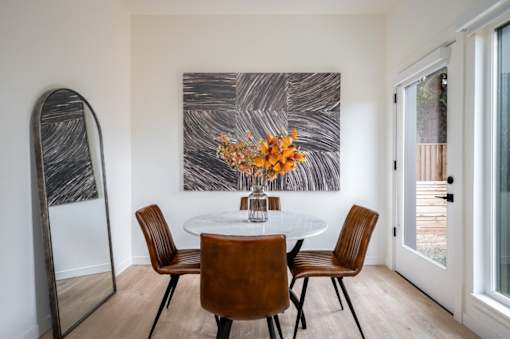 The Wes Gresham Oregon Apartments A dining room with a round table and chairs.