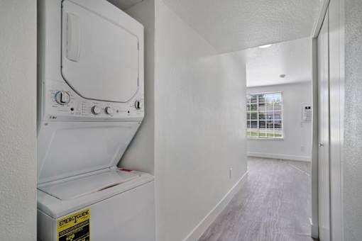 A white fridge in a room with a white wall.