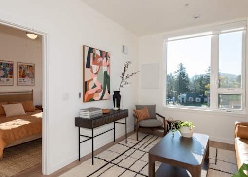 Arts Plaza Gresham Oregon Apartments A living room with a sofa, a table, and a painting on the wall.