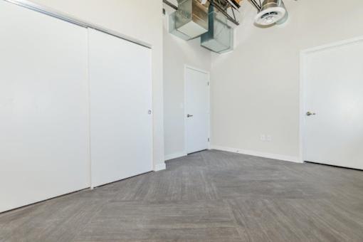 A room with white walls and a grey floor.