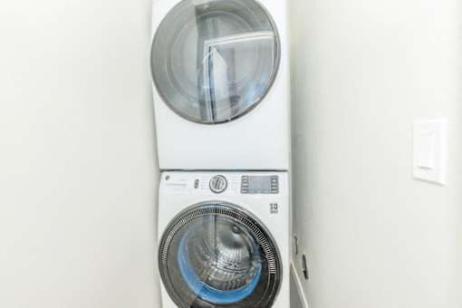 A white washing machine with a blue light on the front.