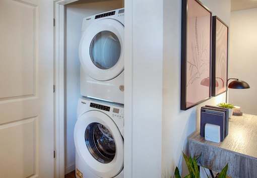 A white washing machine is in a small room.
