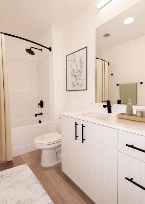 Arts Plaza Gresham Oregon Apartments A white toilet sits in a bathroom next to a sink.