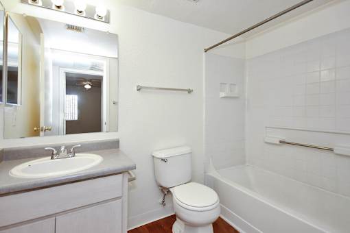 A white toilet sits next to a sink in a bathroom.
