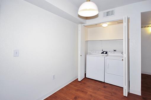 A white bathroom with a white cabinet and a white sink.