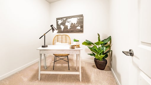 1 Bedroom Den space with desk and plant