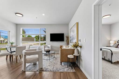 A living room with a television, a sofa, and a coffee table.