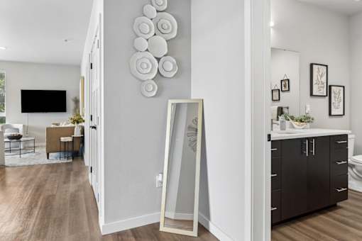 A modern living room with a large mirror and a TV.