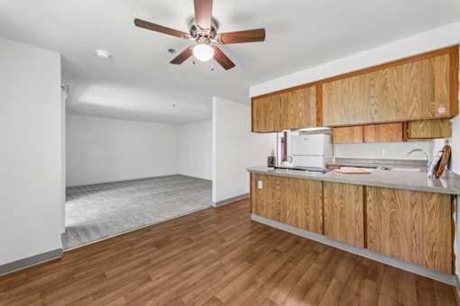 A room with wooden floors and a ceiling fan.