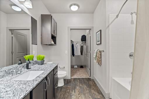 A bathroom with a white tub and a white toilet.