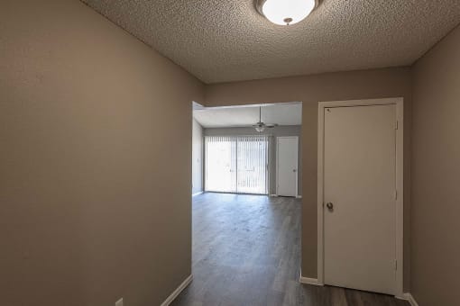 the living room and dining room of an empty house