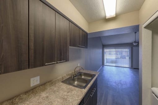 a kitchen with a sink and some wooden cabinets