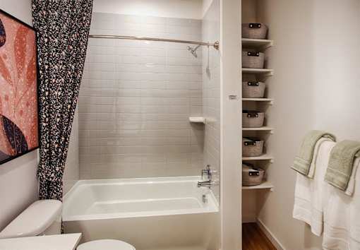 A white bathroom with a tub, toilet, and sink.