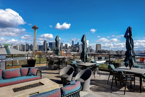 a roof top bar with a view of the seattle skyline