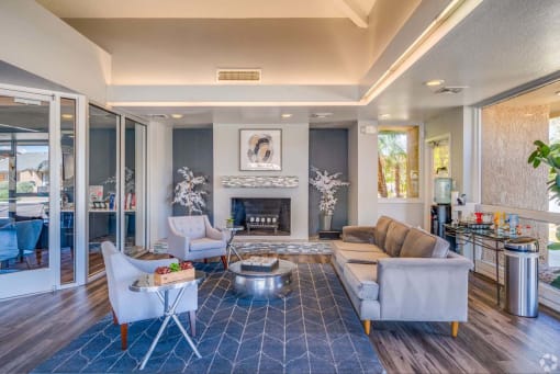 a living room with couches and chairs and a fireplace