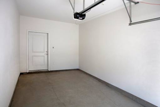 A room with a white door and a white wall.