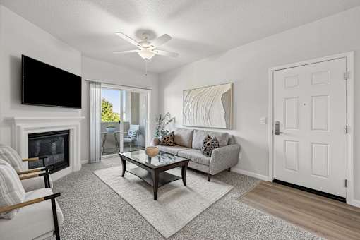 A living room with a fireplace and a television above it.