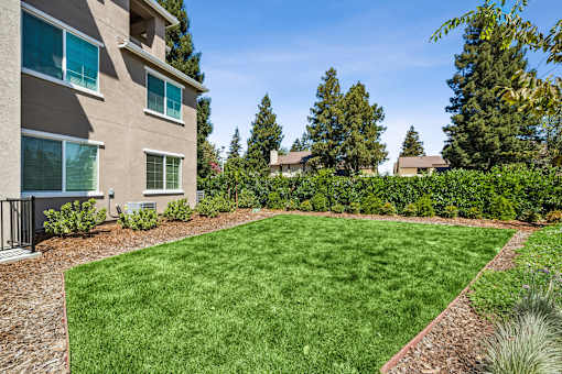 A well-maintained lawn in front of a residential building.