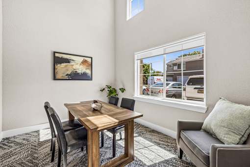 A dining room with a wooden table and chairs.