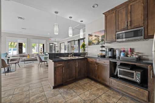 A kitchen with a black counter top and wooden cabinets.