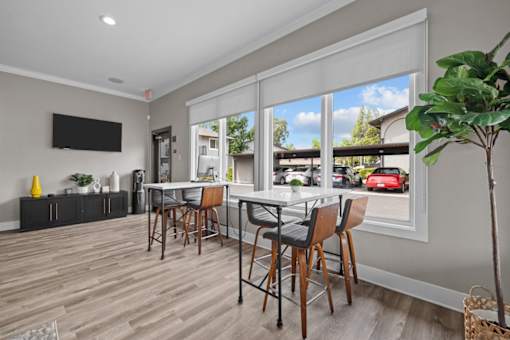 A dining room with a table and chairs.