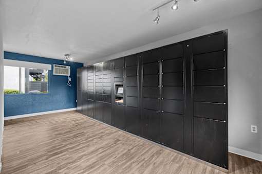 A room with a blue wall and wooden flooring.