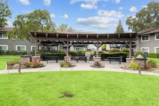 A park area with a bench and a pavilion.
