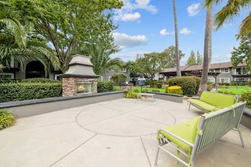 A patio with a fireplace and a bench.