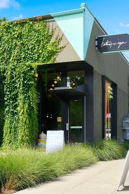 A building with a green plant on the side and a sign that says "Bistro".