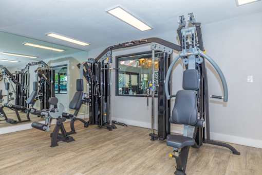 A gym with a variety of equipment including a leg press machine.