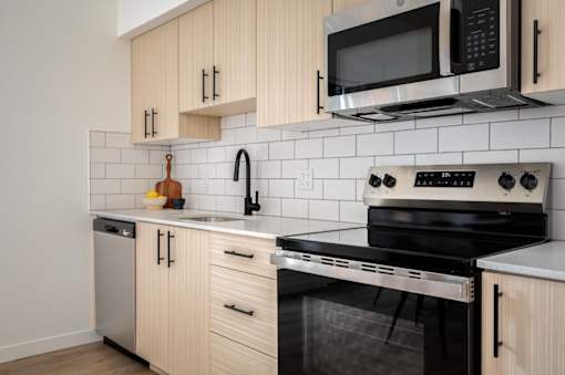 The Wes Gresham Oregon Apartments bright kitchen with stainless steel appliances