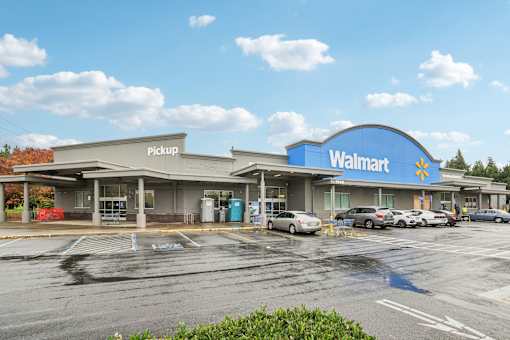 A Walmart store with a pickup area in front.
