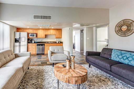 A modern living room with a grey couch and a wooden coffee table.