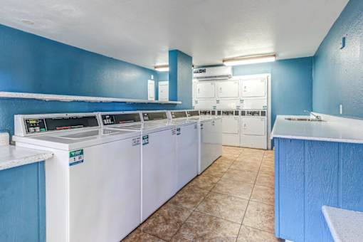 A laundry room with washers and dryers.