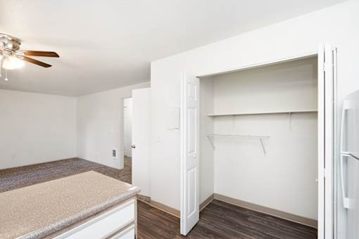 A room with a ceiling fan and a countertop.