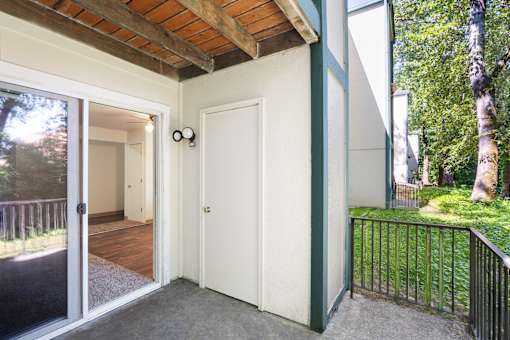 A white door is on the right side of a black fence.