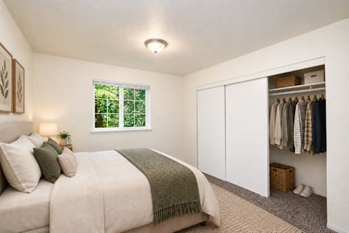 A bedroom with a large bed and a wardrobe.