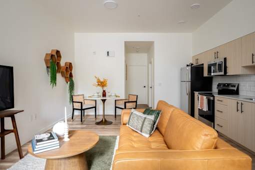 The Wes Gresham Oregon Apartments A living room with a brown couch and a wooden coffee table.