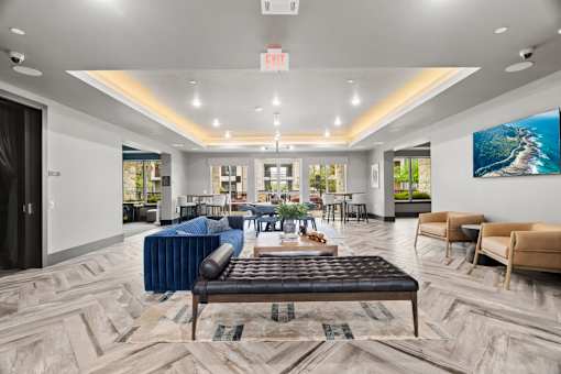 A spacious waiting area with a variety of seating options and a large painting on the wall.