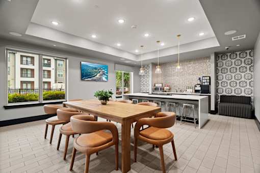 A modern dining room with a wooden table and chairs.