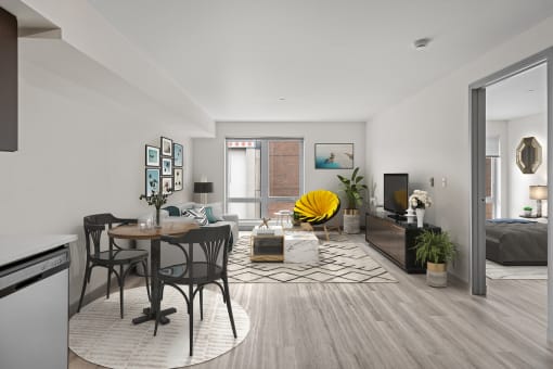 a living room and dining room with a table and chairs