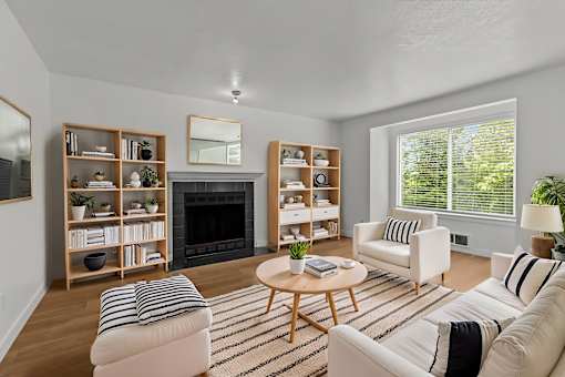 A living room with a fireplace and a coffee table.