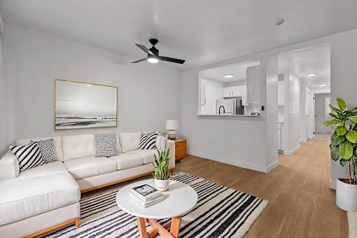 A living room with a white couch and a coffee table.