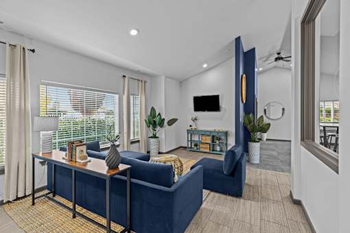 A living room with a blue couch and a television.