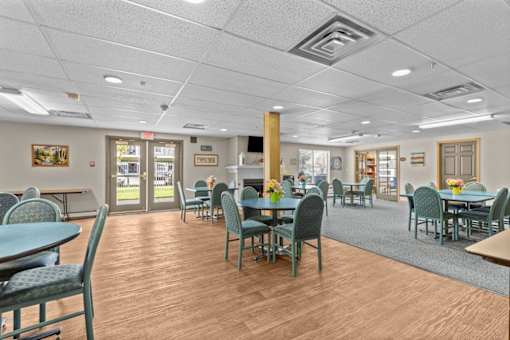 A cafeteria with tables and chairs.
